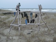 Driftwood sculpture on Bryans Beach, Ohiwa. The footwear are called jandals in NZ